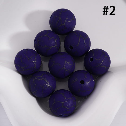 Purple marbled beads on a white surface