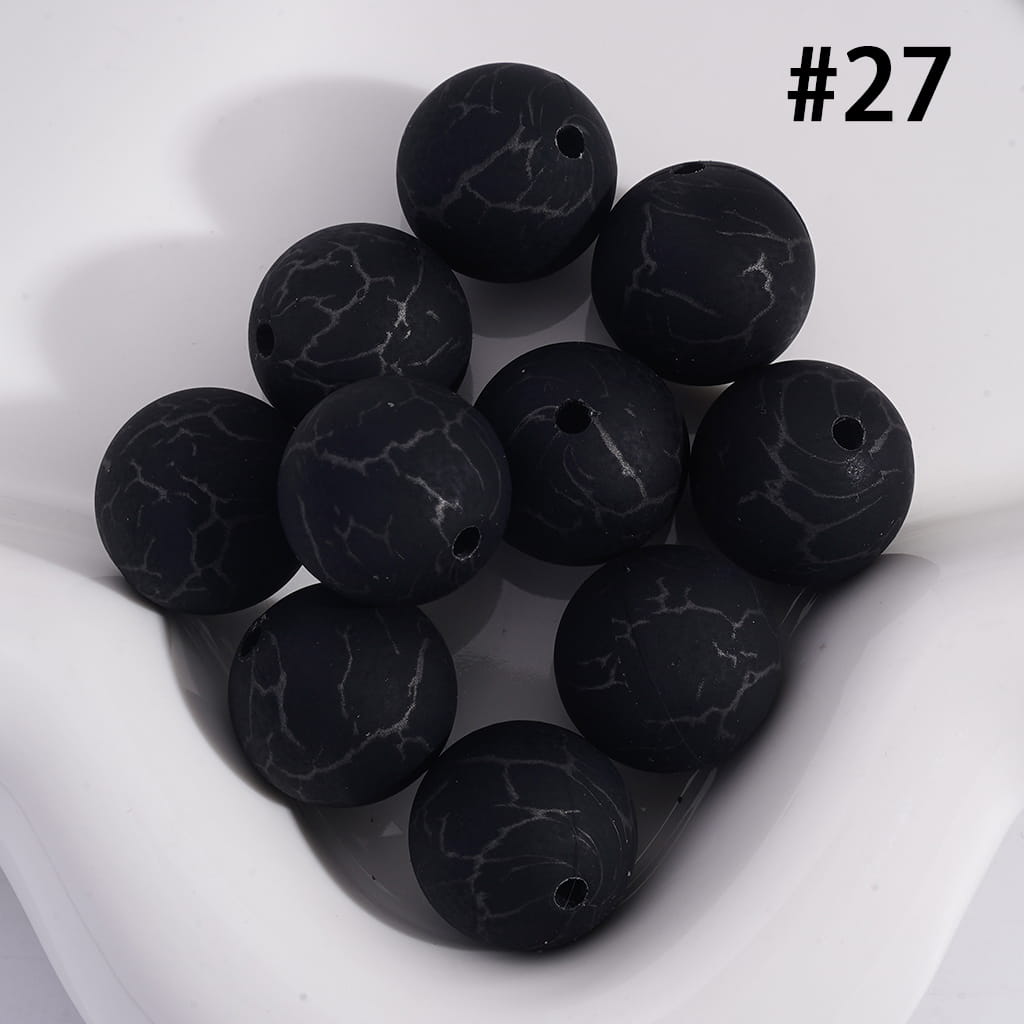 Black marbled beads on a white background