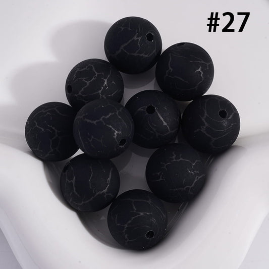 Black marbled beads on a white background