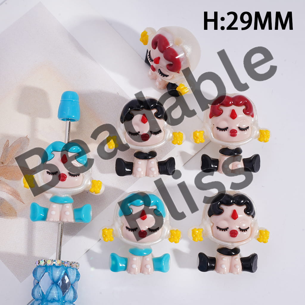 Colorful character-shaped earrings on a white background with 'handsontupply.com' branding.