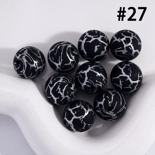 Black and white marbled beads on a white surface with the number 27 displayed.