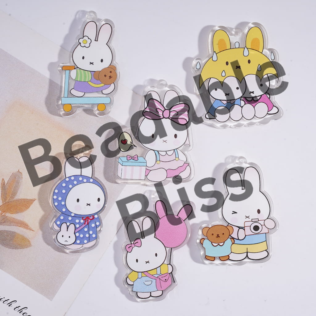 Set of cartoon rabbit figurines with various accessories on a white background.