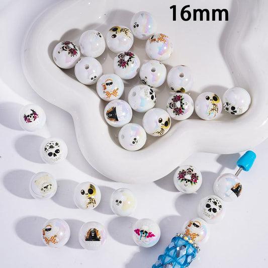 White beads with various colorful designs on a white surface, with a dropper visible.