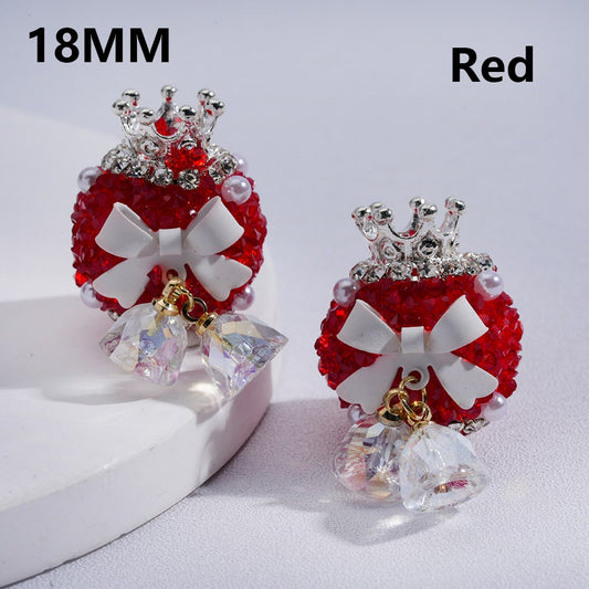 Red and silver earrings with a bow design on a white background


