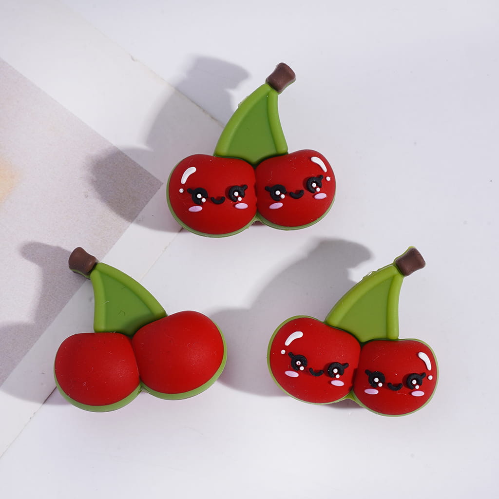 Pair of cherry-shaped earrings with a white background