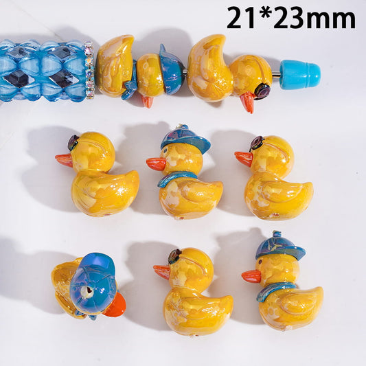 Small rubber duck toys with blue hats on a white background, with dimensions 21*23mm.