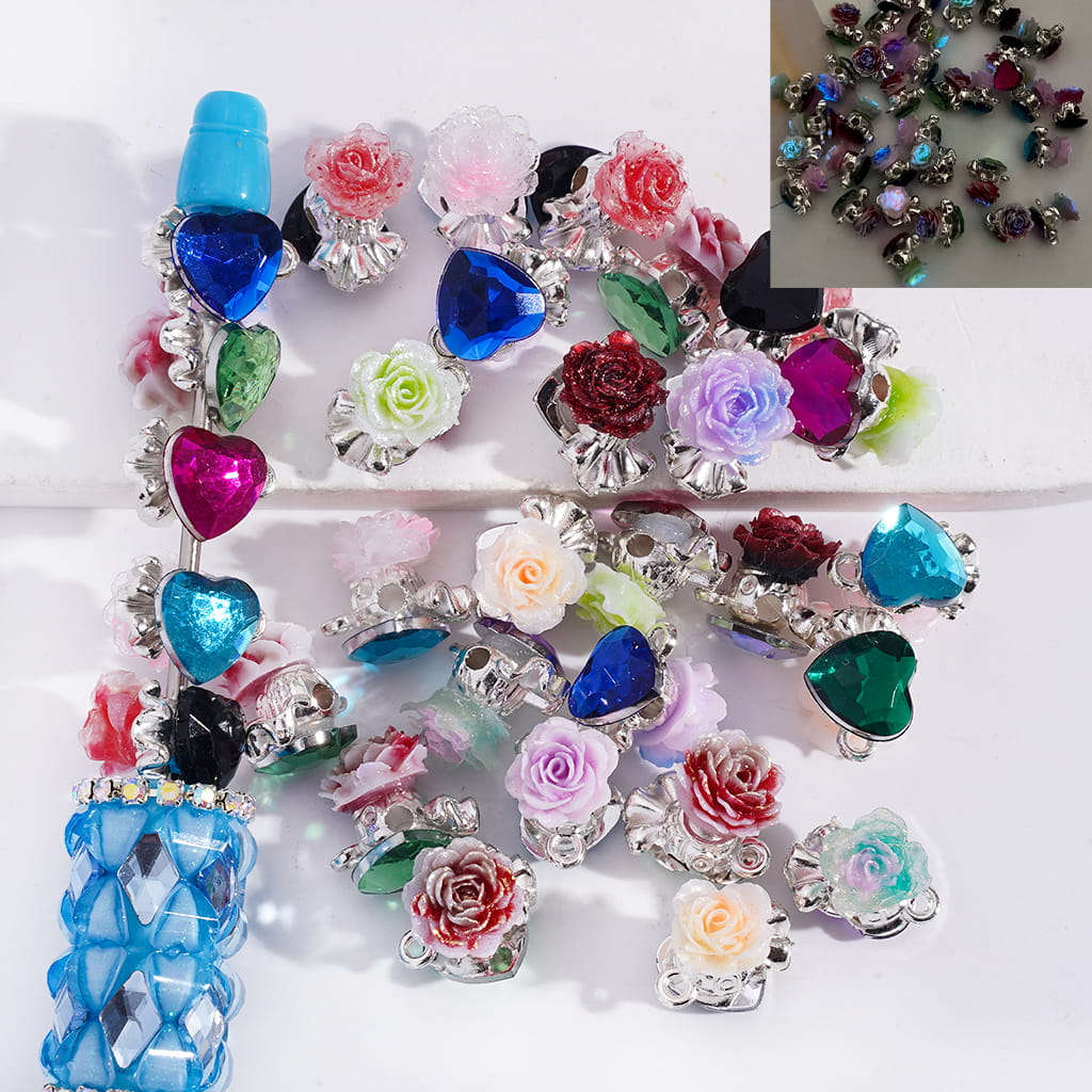 Colorful decorative charms with floral and heart designs on a white background.