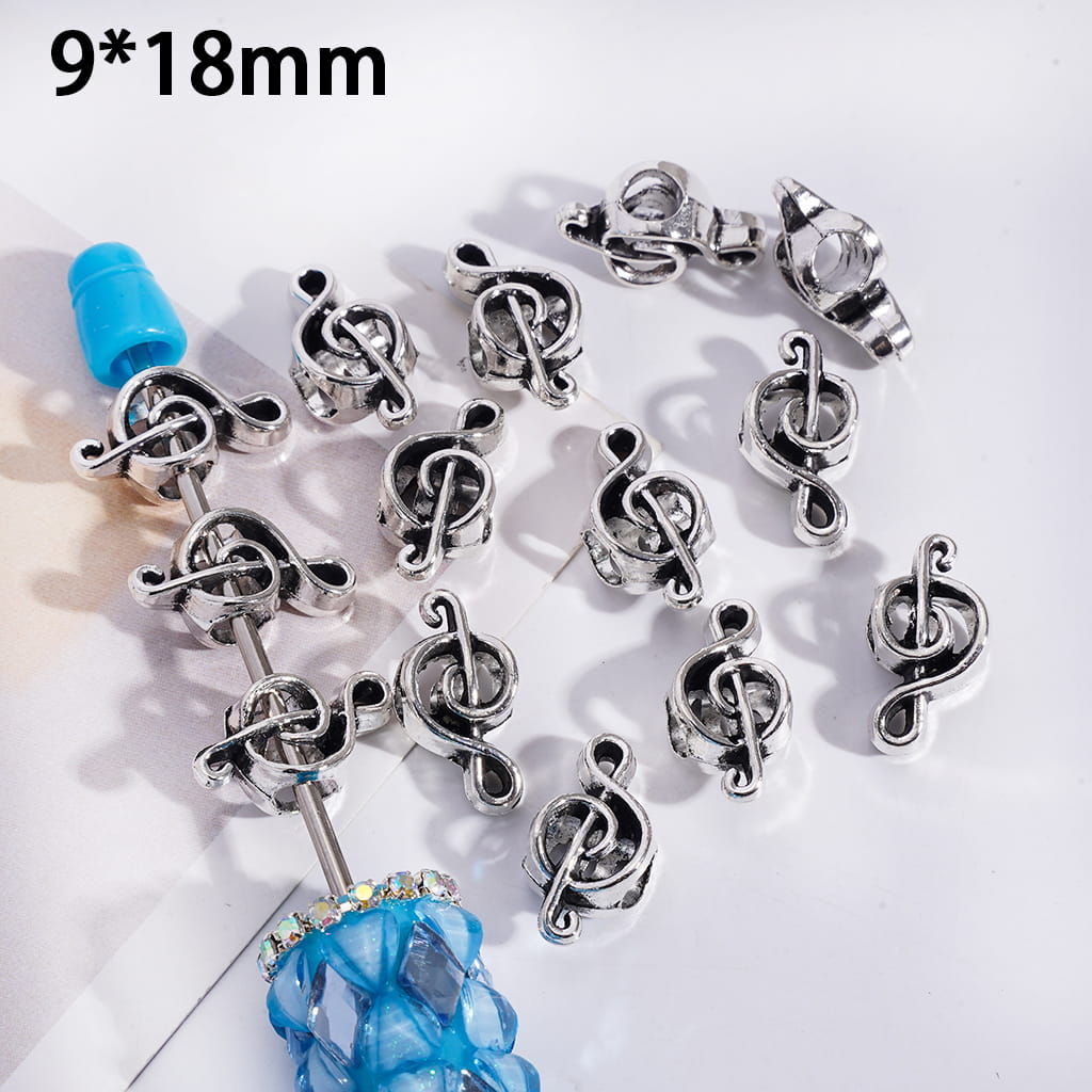 Silver music note earrings on a white background with '9*18mm' text.
