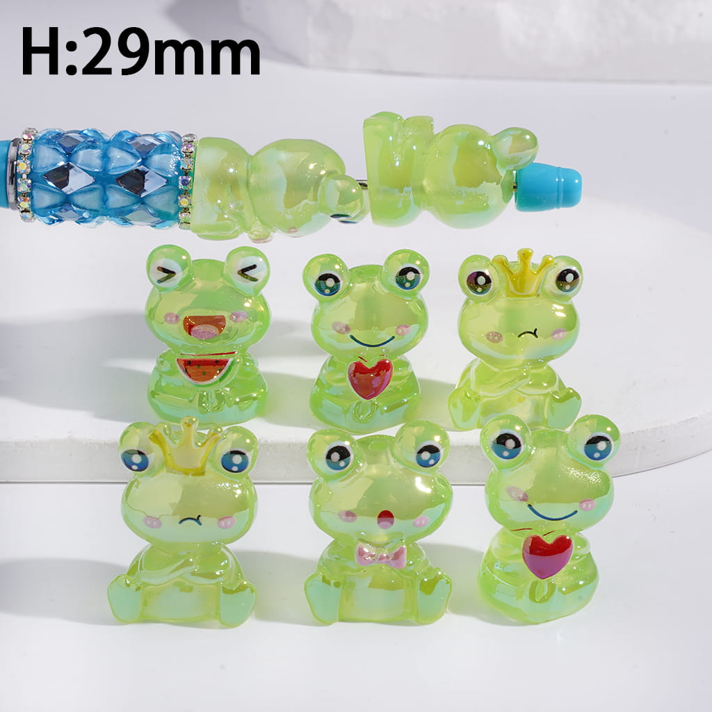 Set of green frog-shaped figurines with a blue and clear object labeled 'H:29mm' on a white background.