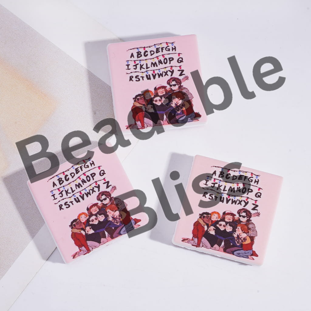 Three pink cards with a group of people and alphabet text, on a white background with 'handsontosupply.com' text.
