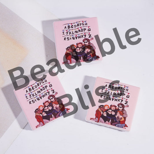 Three pink cards with a group of people and alphabet text, on a white background with 'handsontosupply.com' text.