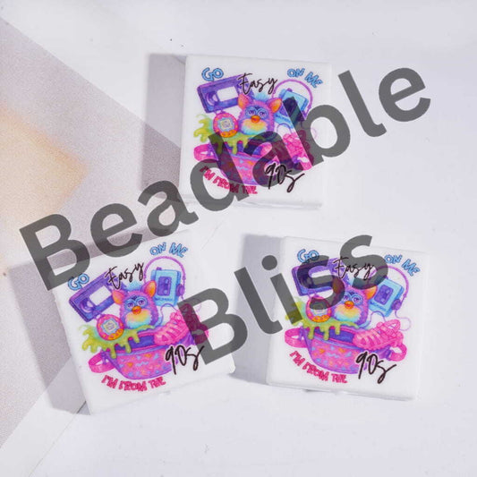 Three colorful t-shirts with cartoon designs and text on a white background, featuring the brand 'handsontosupply'.com'.