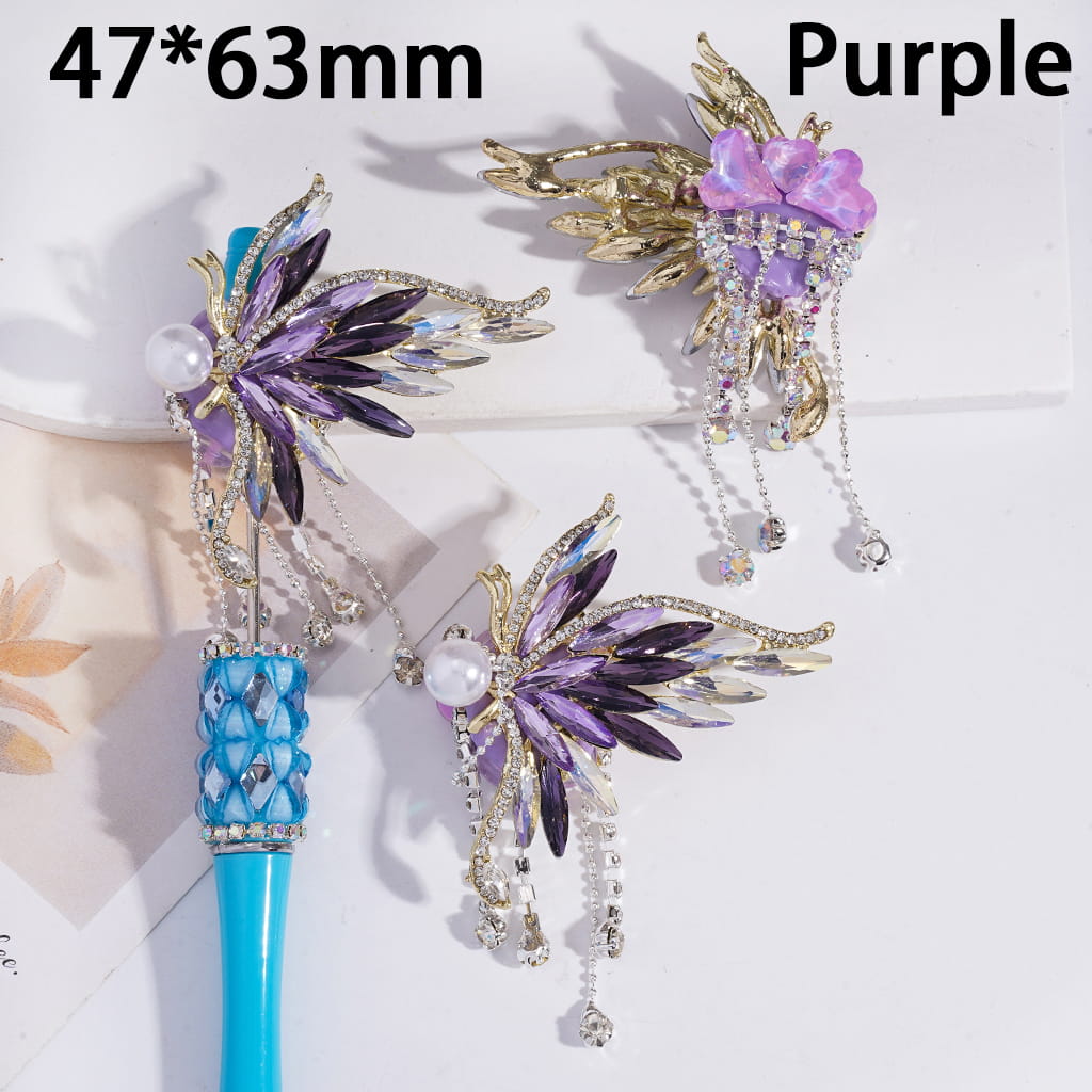 Decorative hair sticks with purple and gold design on a white background
