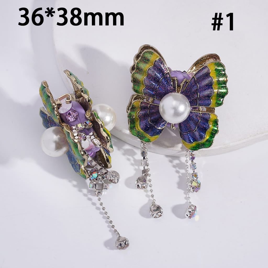 Butterfly-shaped earrings with pearl and gemstone details on a white background