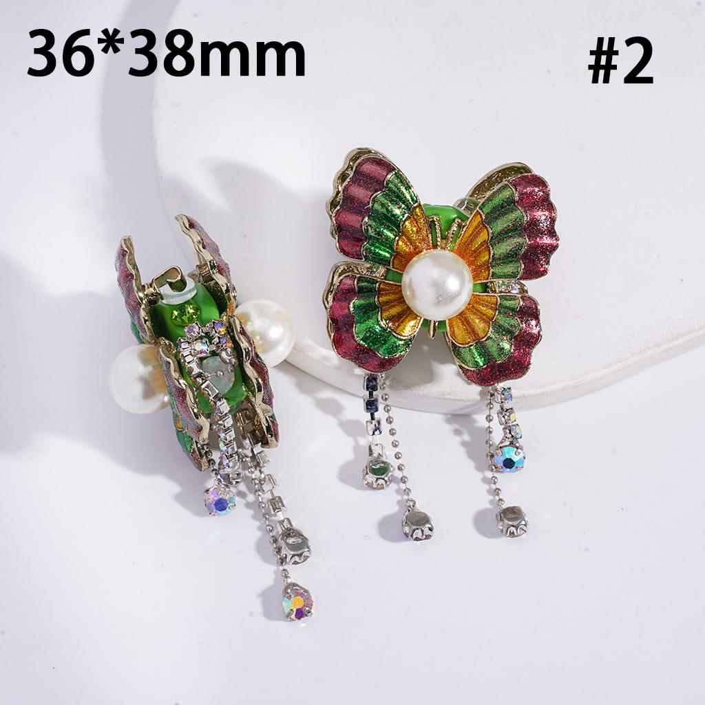 Colorful butterfly-shaped earrings with pearl center on a white background