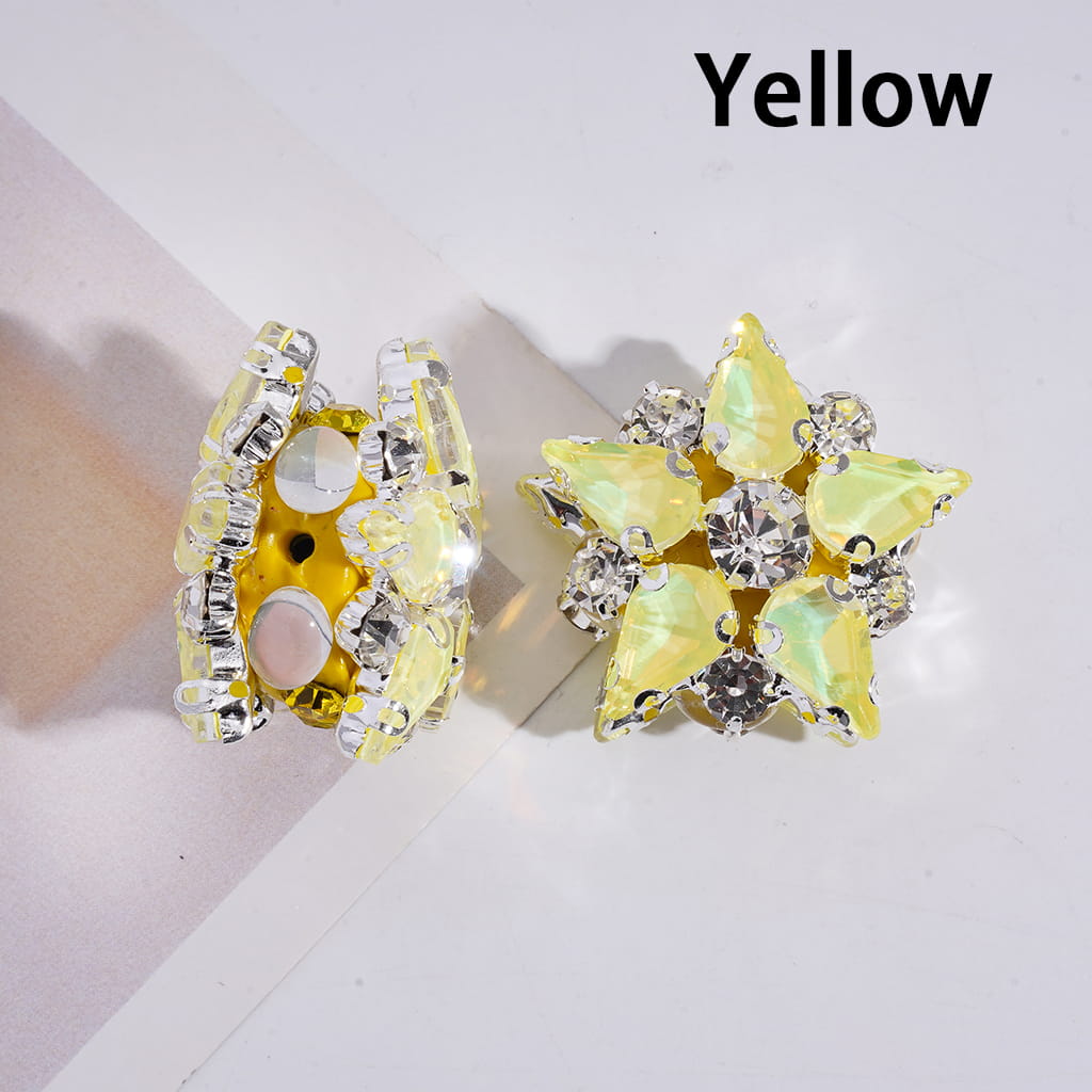Yellow star-shaped earrings with rhinestones on a light background