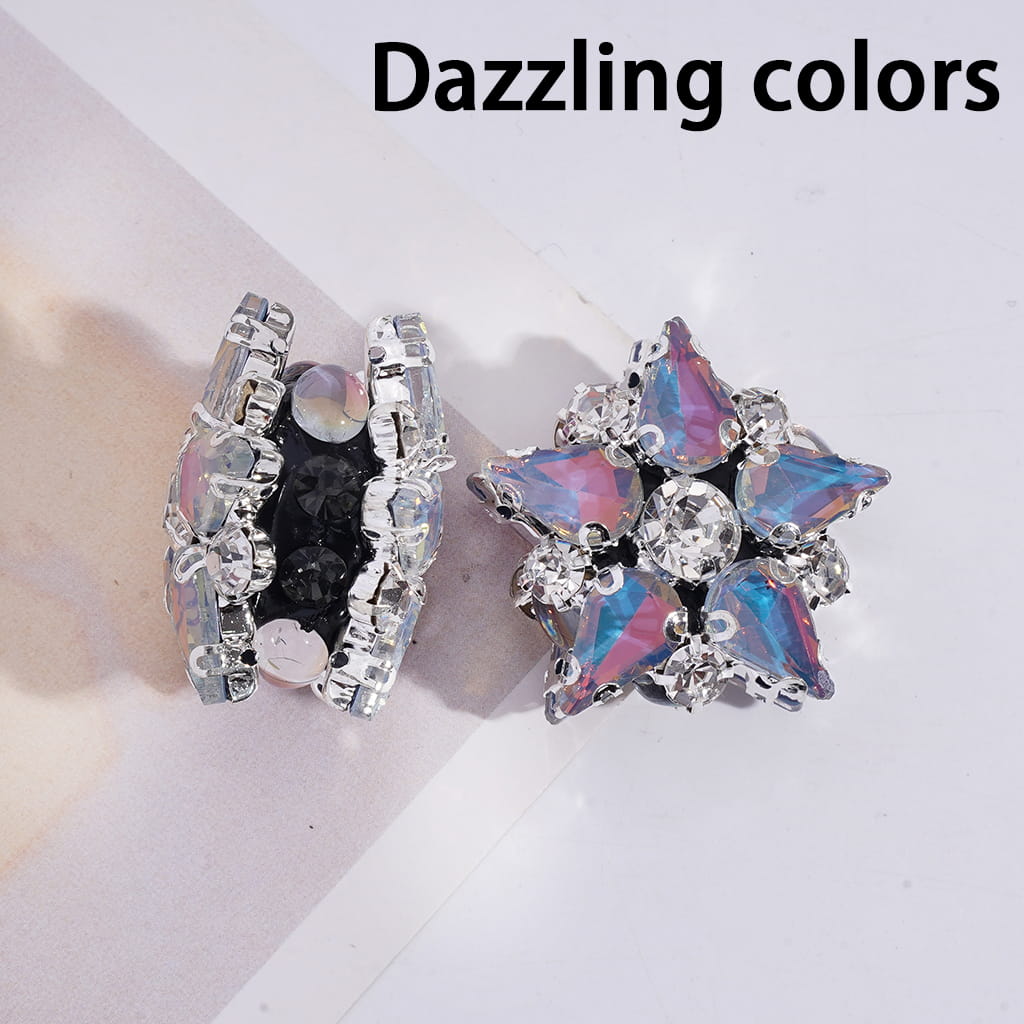 Two earrings with iridescent and black gemstones on a light background.