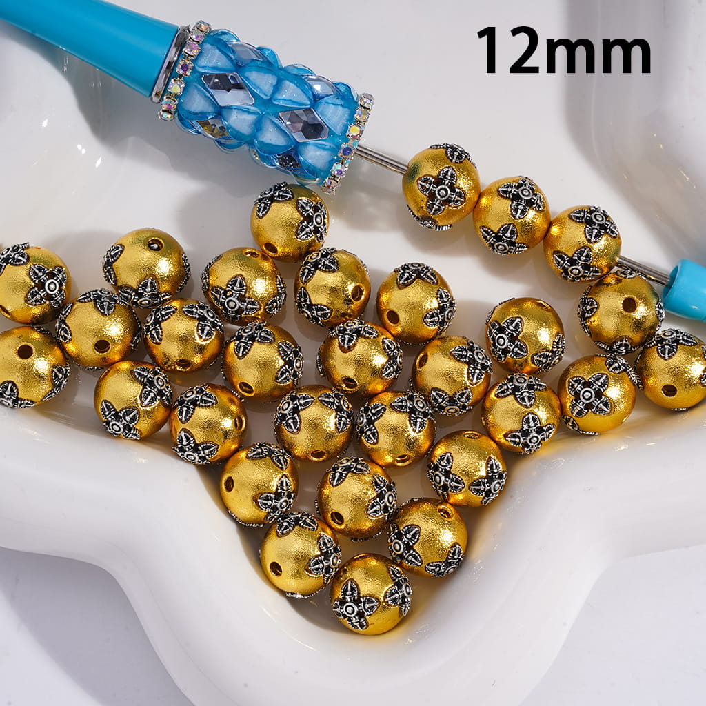 Gold beads with decorative patterns on a white background, labeled '12mm'.
