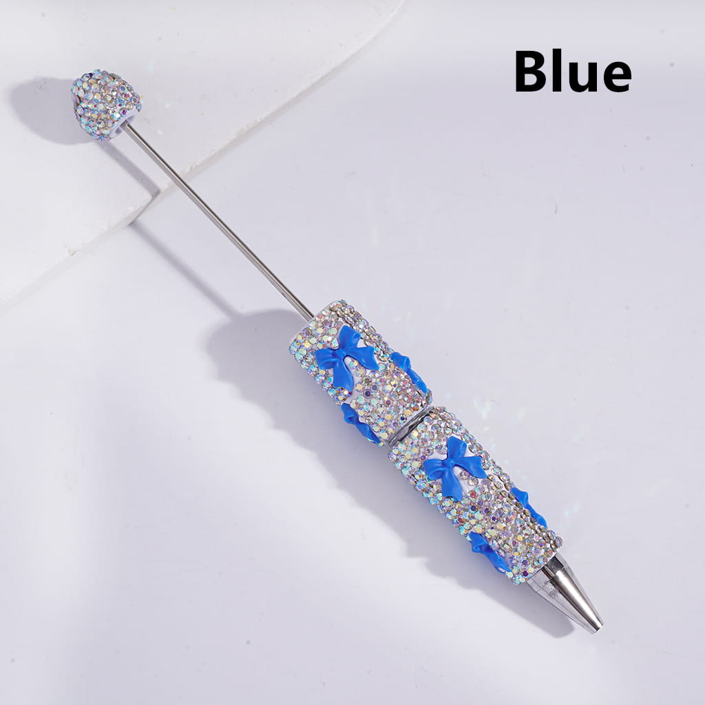 Blue decorative pen with gemstone accents on a white background