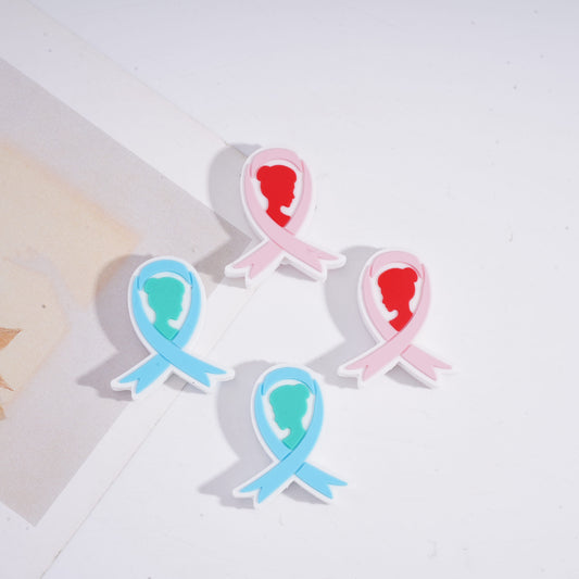 Two ribbon-shaped pins, one pink and one blue, on a light background.