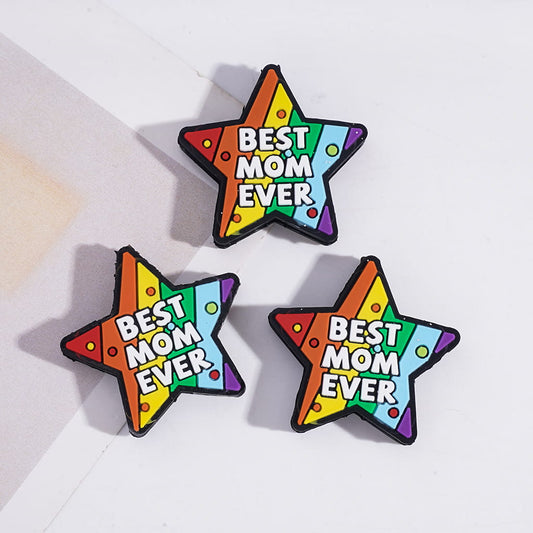 Three rainbow-colored star-shaped pins with 'Best Mom Ever' text on a light background