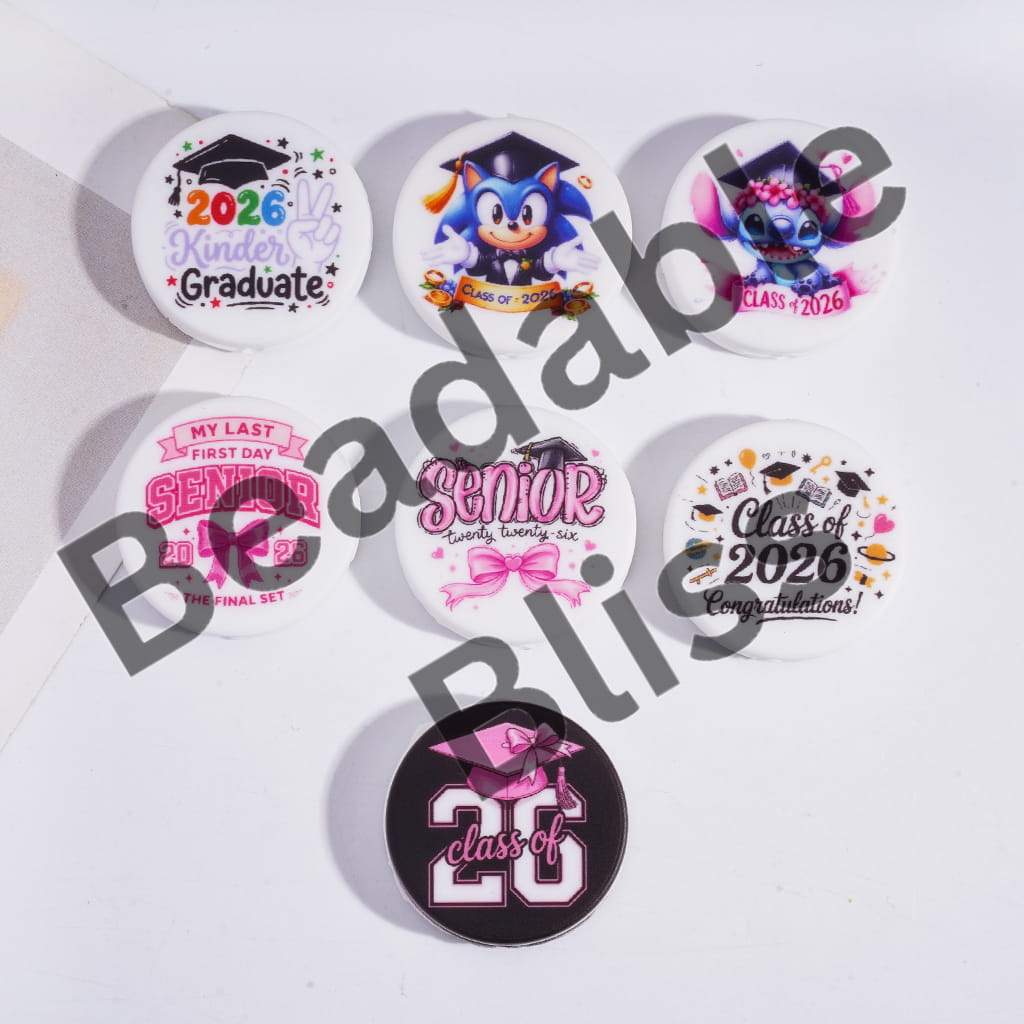Set of graduation-themed buttons with various designs on a white background
