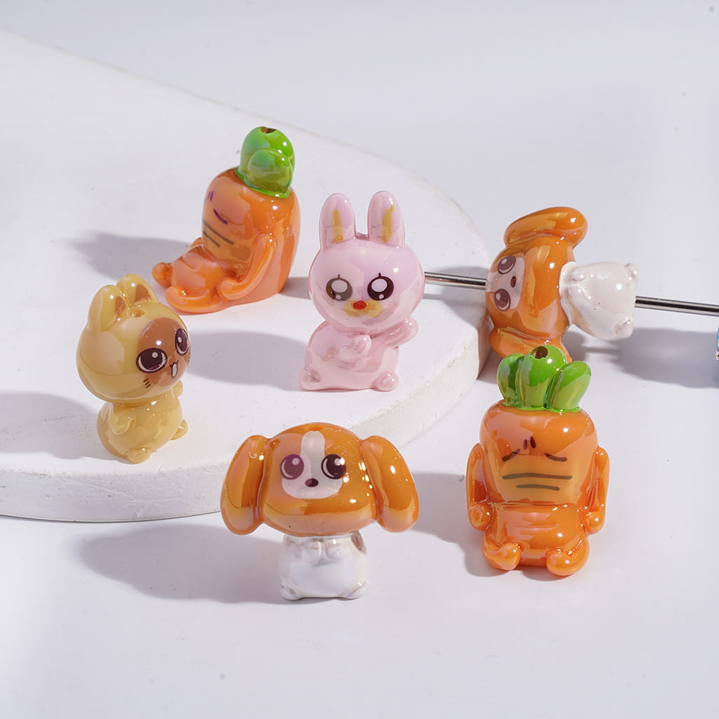 Set of colorful animal-shaped beads on a white background