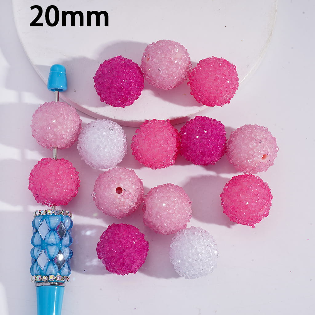 Set of pink and white beads with a blue handle on a white background