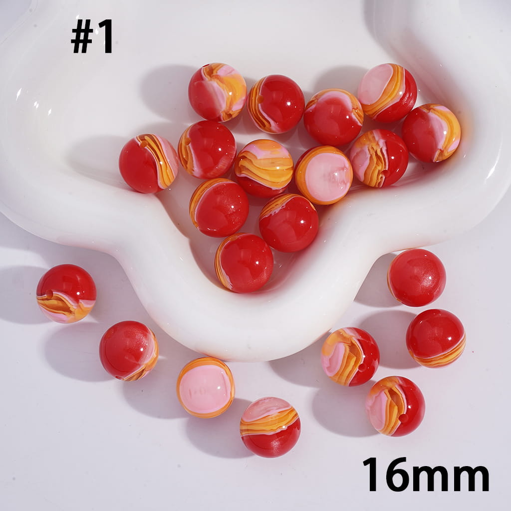Marbled red, orange, and pink beads on a white dish with '16mm' text.
