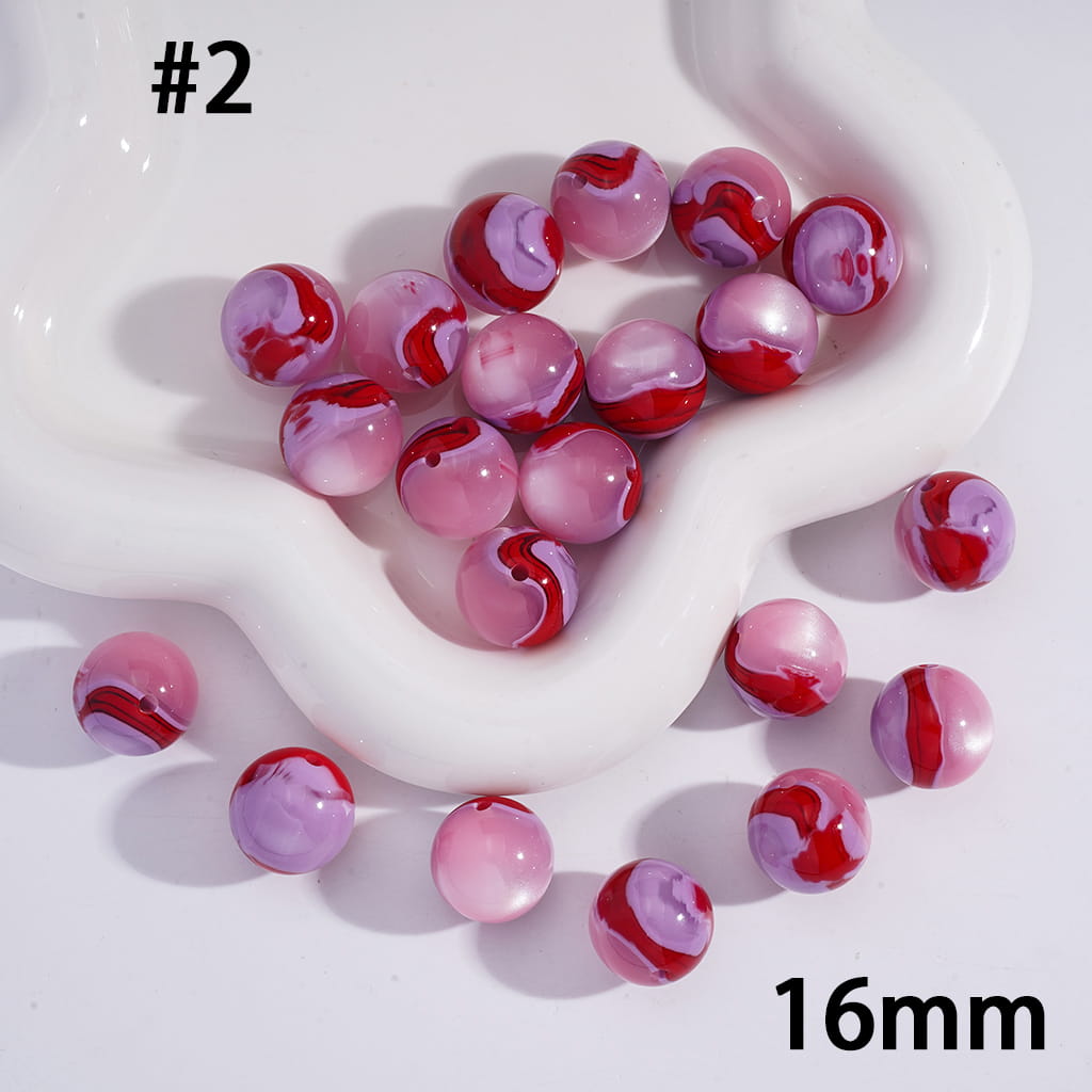 Marbled red and pink beads on a white heart-shaped dish with '16mm' text.