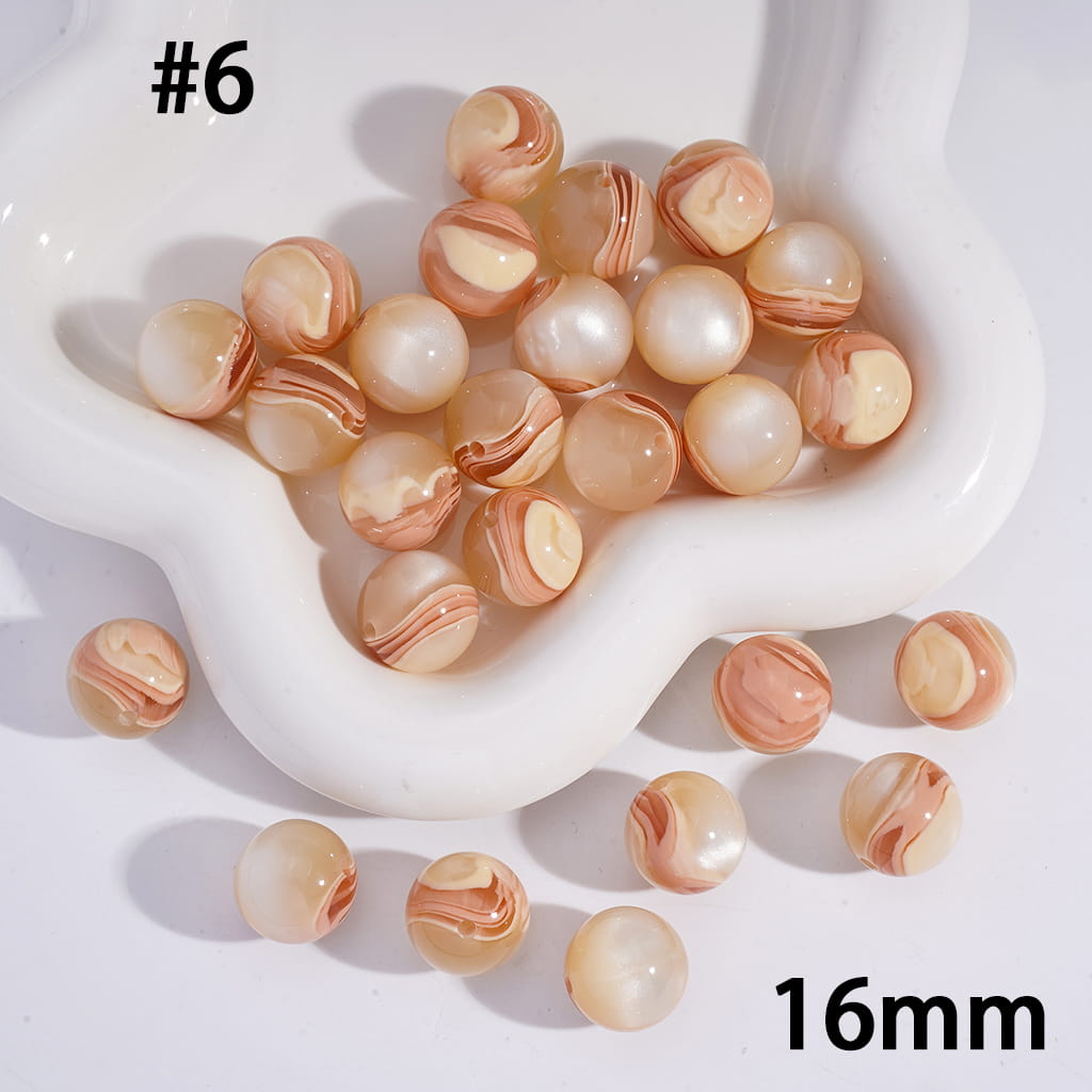 Marbled beads in a white dish with '16mm' text on a light background