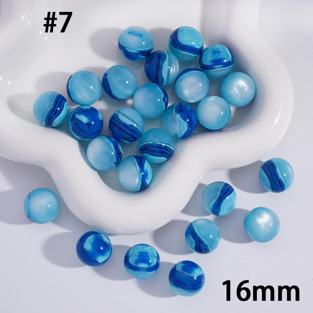 Blue marbled beads on a white dish with '16mm' text