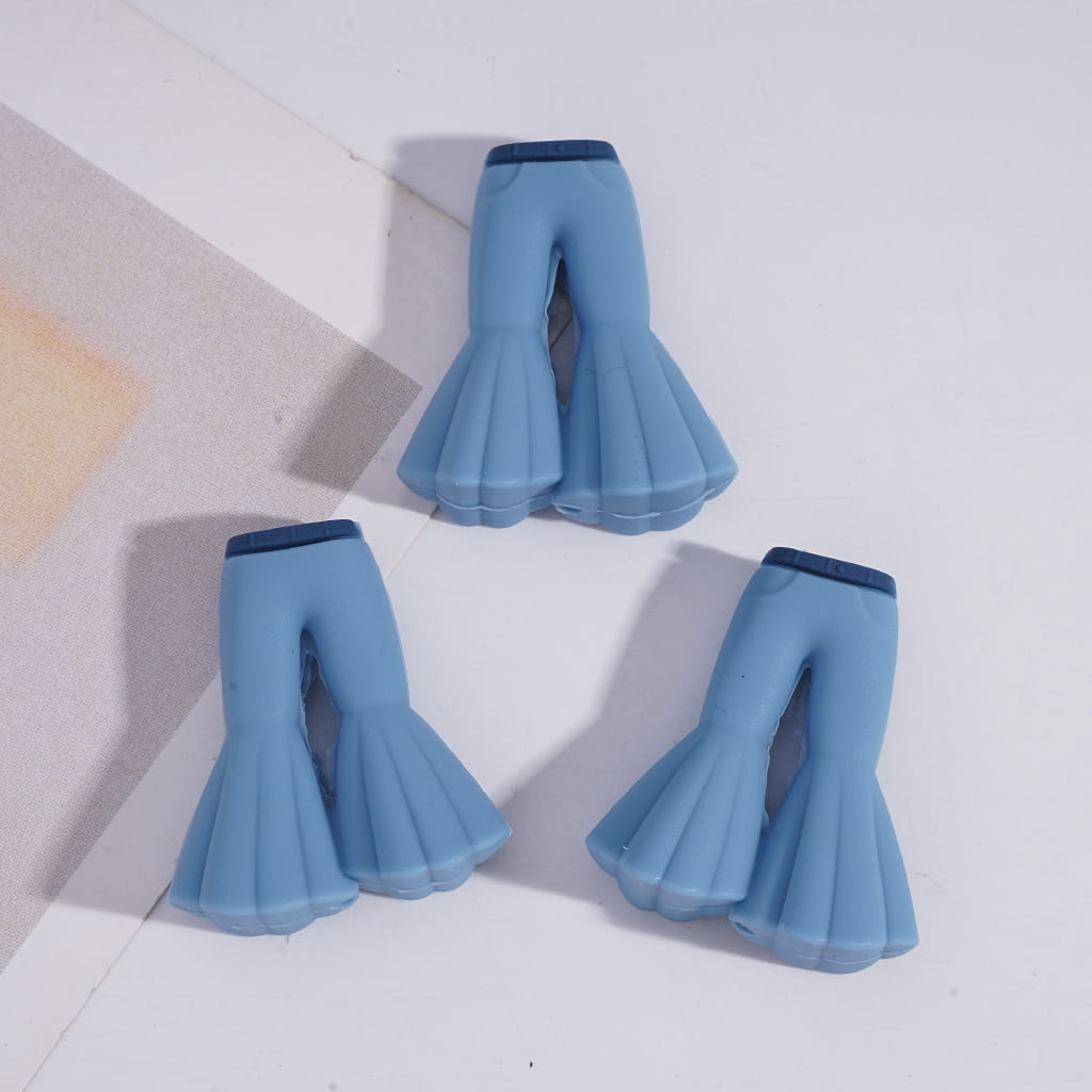 Set of blue bell-bottom pants on a light gray background