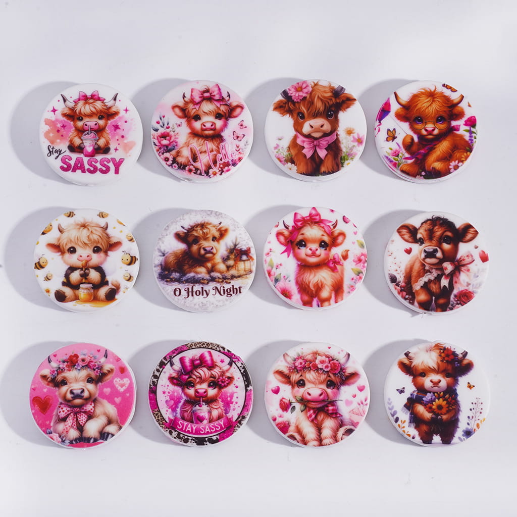 Set of 12 decorative buttons with cartoon cows and festive text on a white background