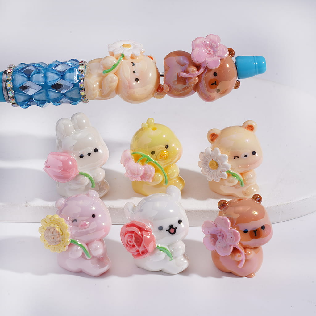 Set of small animal figurines with flowers on a white background