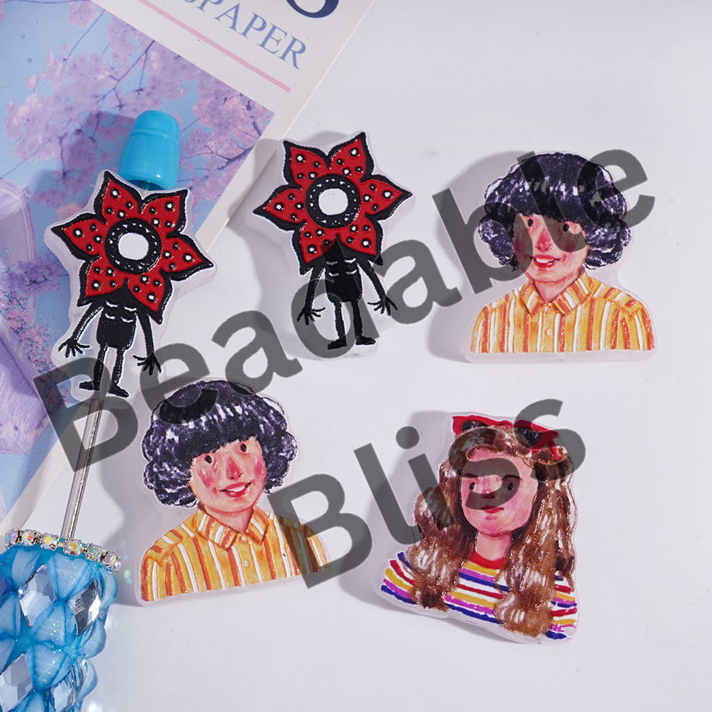 Set of colorful brooches with stylized illustrations of people on a white background.