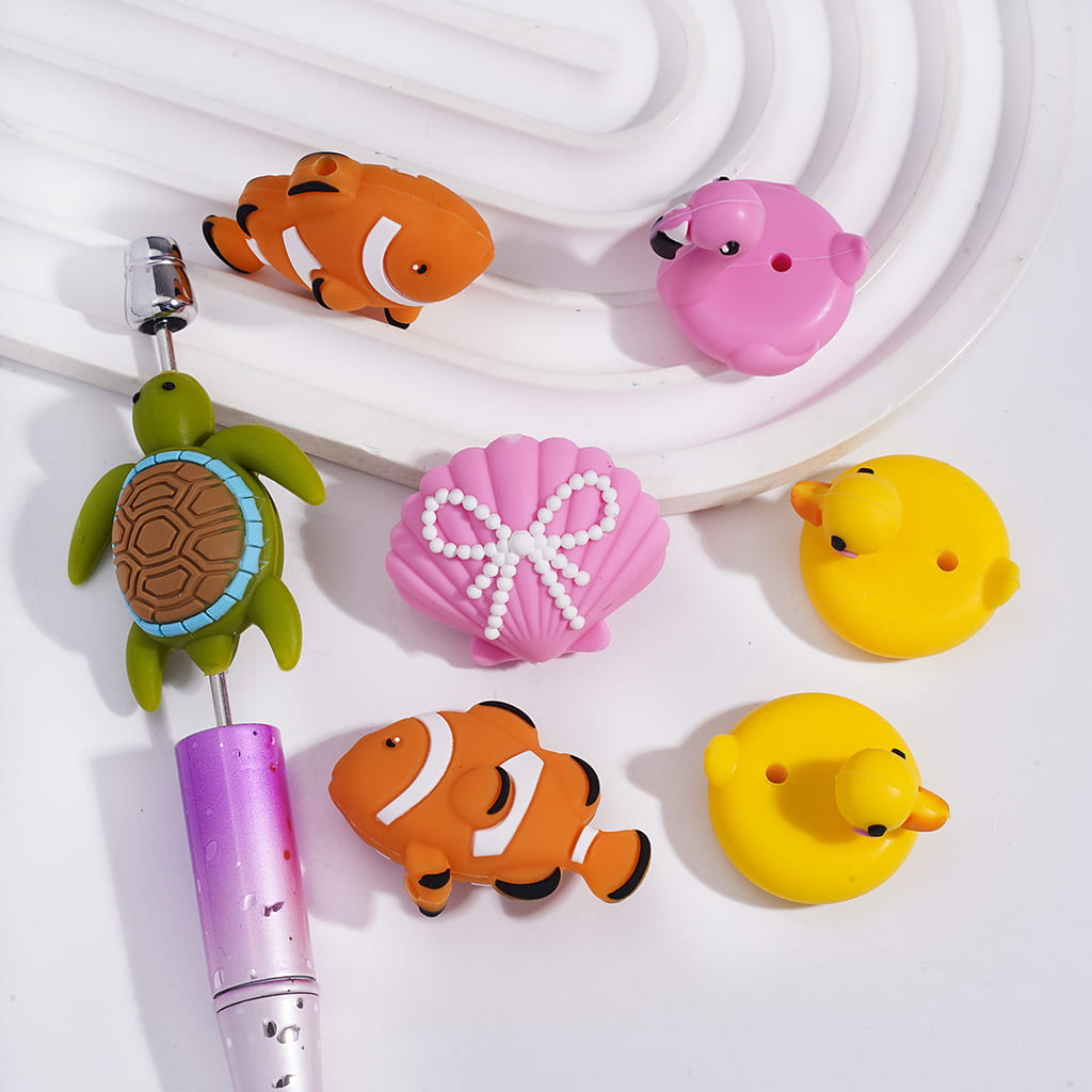Colorful animal-shaped phone charms on a white background

