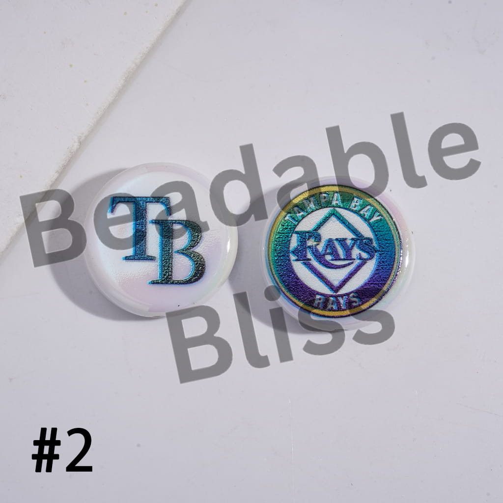 Two round pins with 'TB' and 'Tampa Bay Rays' logos on a white background with 'Beadable Bliss' branding.

