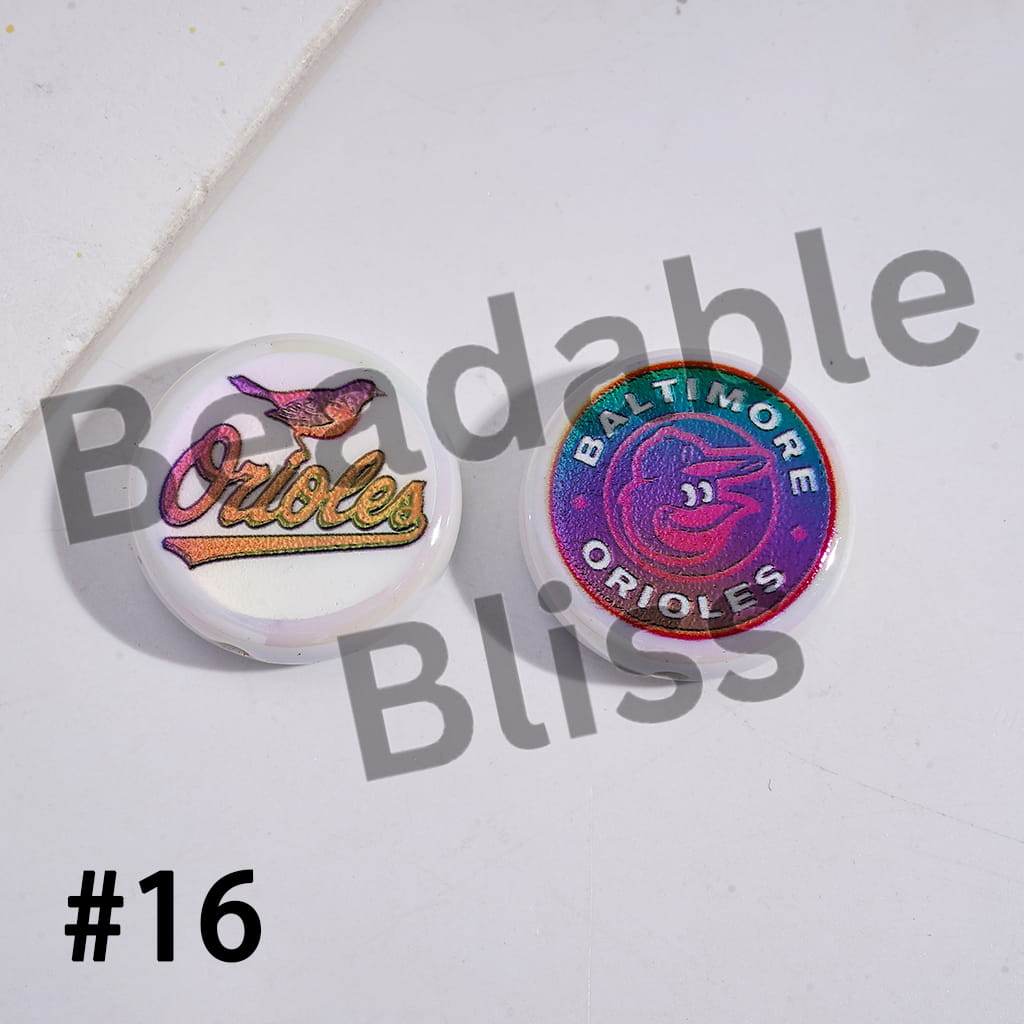 Two colorful pins with 'Baltimore Orioles' branding on a light background.

