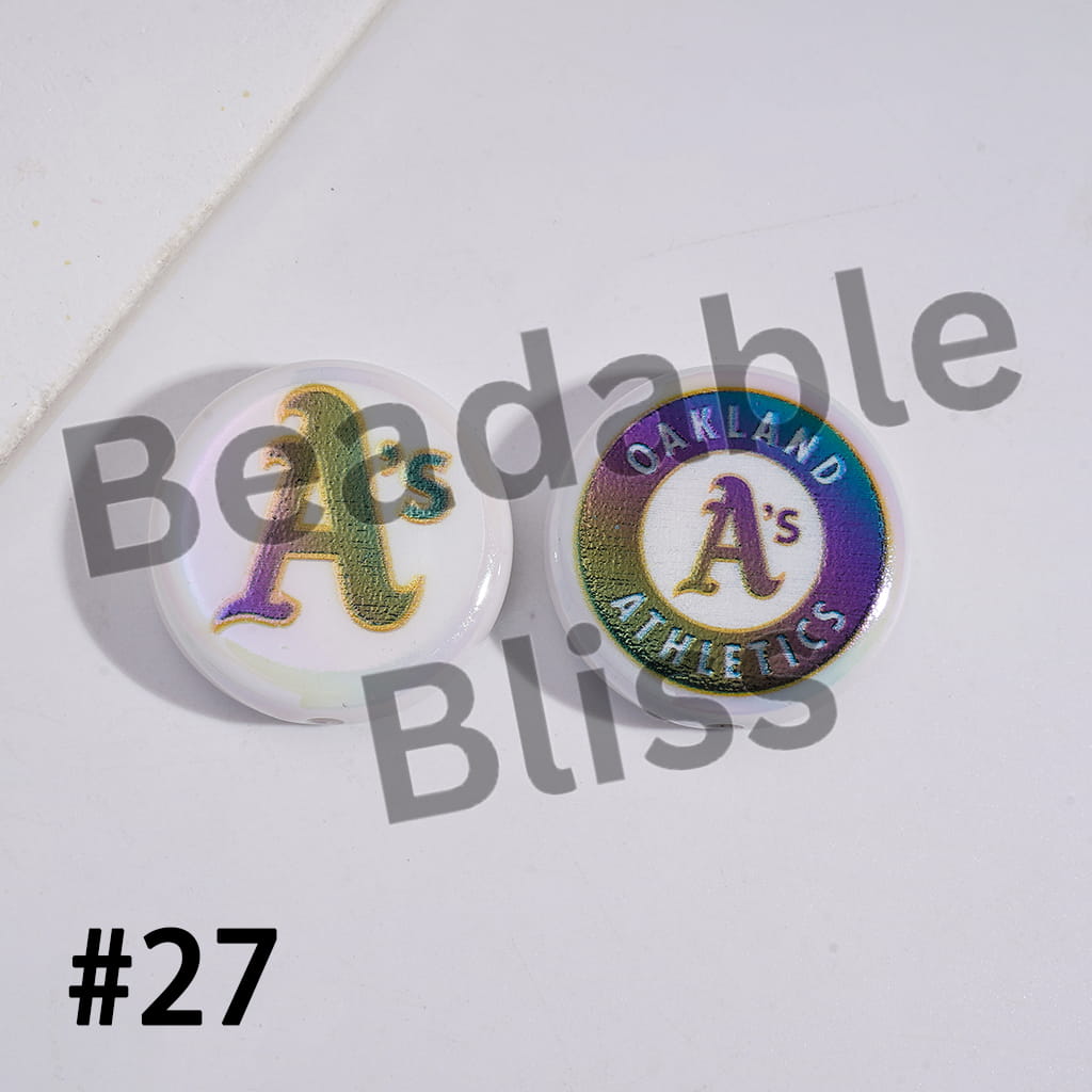 Two round pins with 'Oakland Athletics' logo on a white background with 'Bendable Bliss' text.


