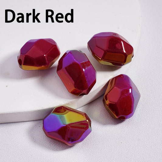 Dark red faceted beads on a white background


