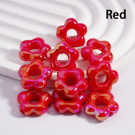 Red flower-shaped beads on a white background

