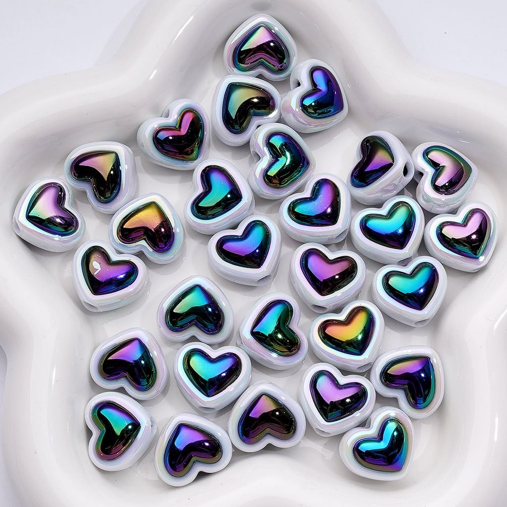 Heart-shaped objects with iridescent surface on a white background

