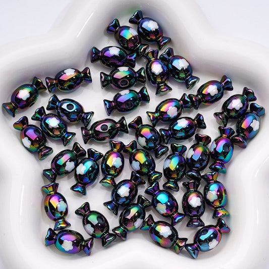 Iridescent candy-shaped beads on a white plate

