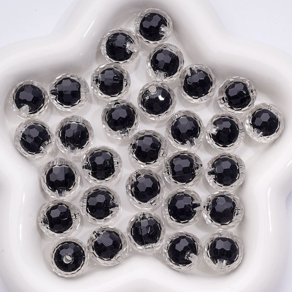 Black beads in clear gel on a white plate

