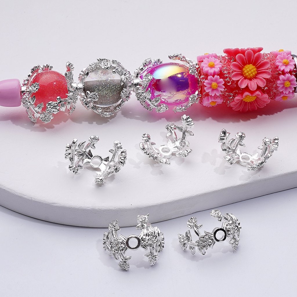 Silver earrings with pink and silver beads on a white background

