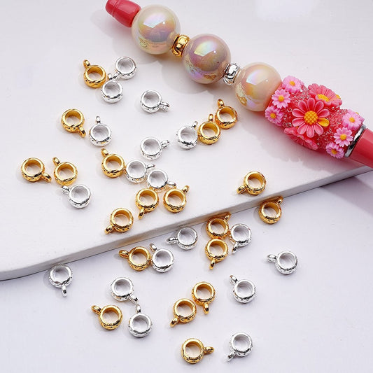 Jewelry clasp connectors in gold, silver, and rose gold on a white background with a floral beaded necklace.

