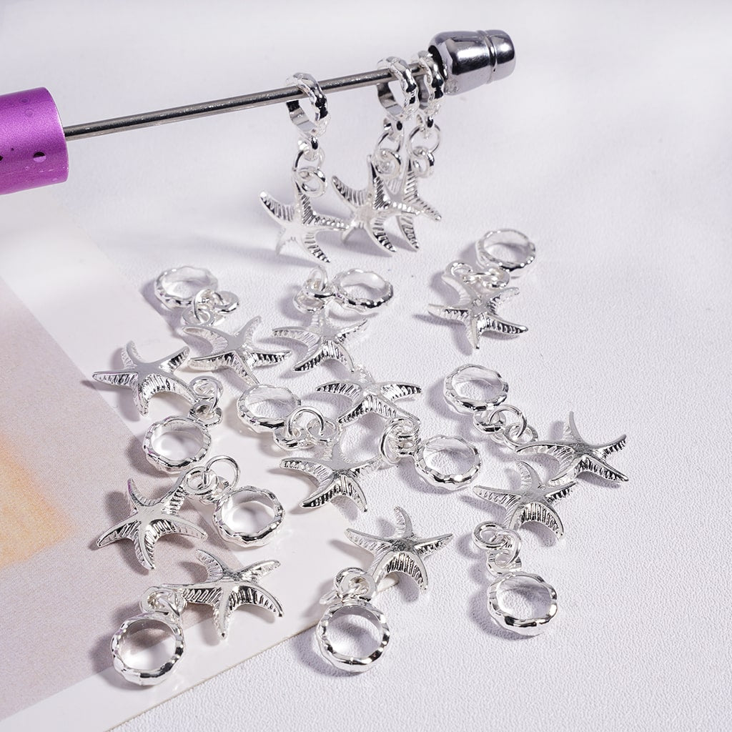 Silver starfish-shaped jewelry components on a white background
