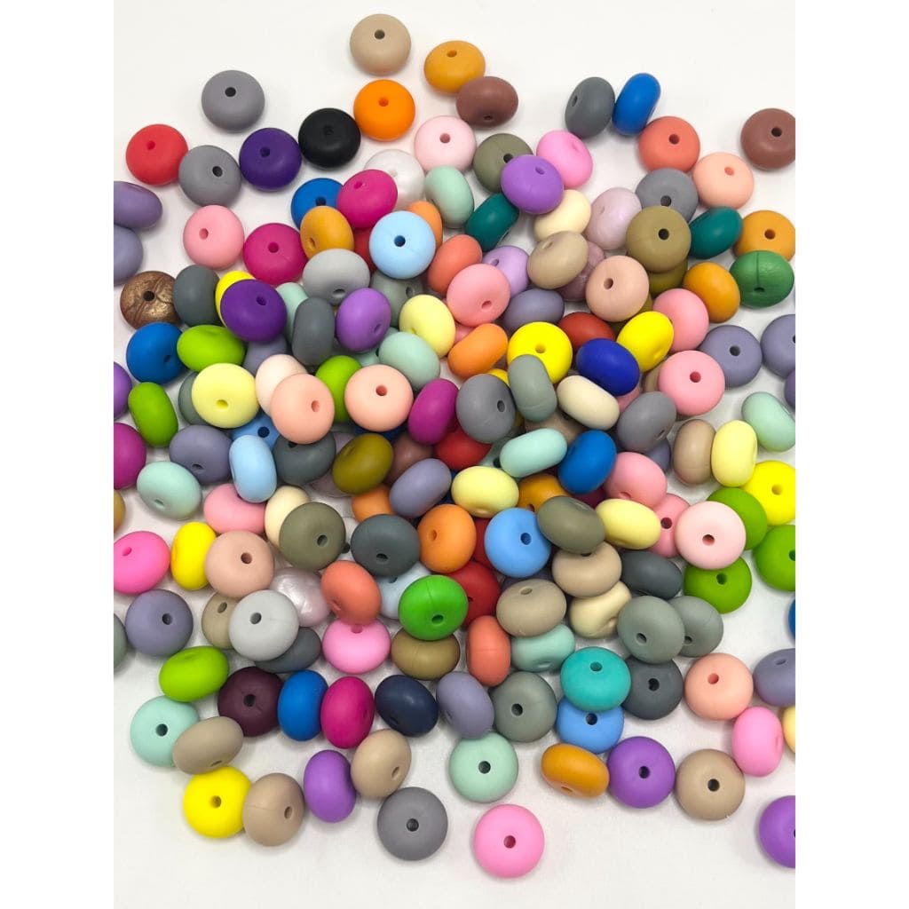 Assorted colorful round beads on a white background

