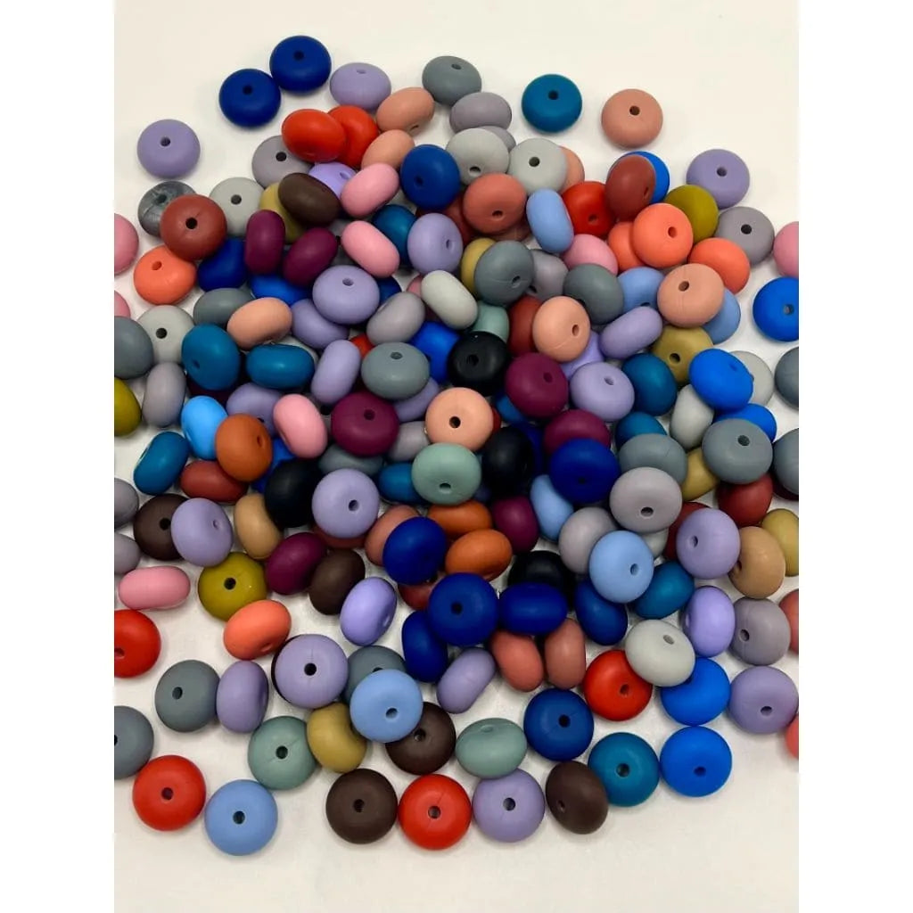 Assorted colorful beads on a light background

